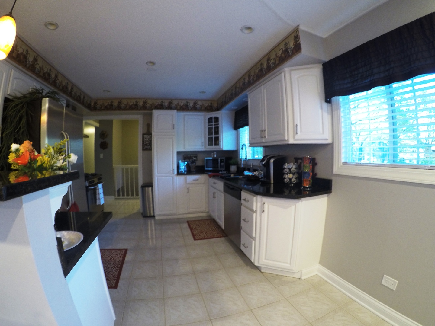 3N445 Rohlwing Road Addison, IL 60101 - Photo 4 of 19 a kitchen with stainless steel appliances a refrigerator sink and microwave