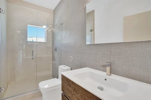 a bathroom with a sink toilet and shower