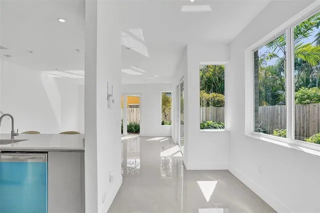 a living room with furniture and large windows