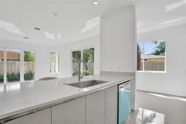 a kitchen with a sink and large window
