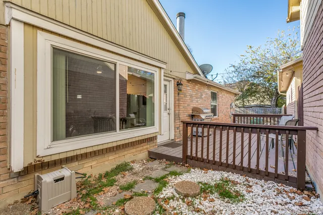 a view of a house with a small yard and wooden floor and fence