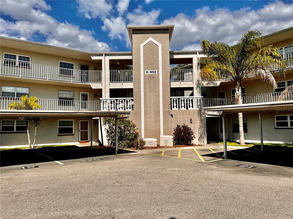 952 Virginia Street, Unit 103 Dunedin, FL 34698 - Photo 1 of 1 a view of a building with a street
