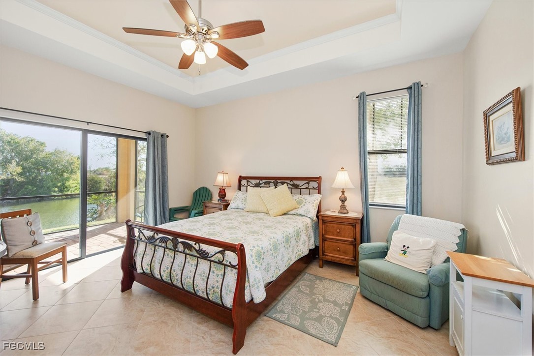 2011 Northwest 9th Place Cape Coral, FL 33993 - Photo 11 of 22 a bedroom with a bed and a couch