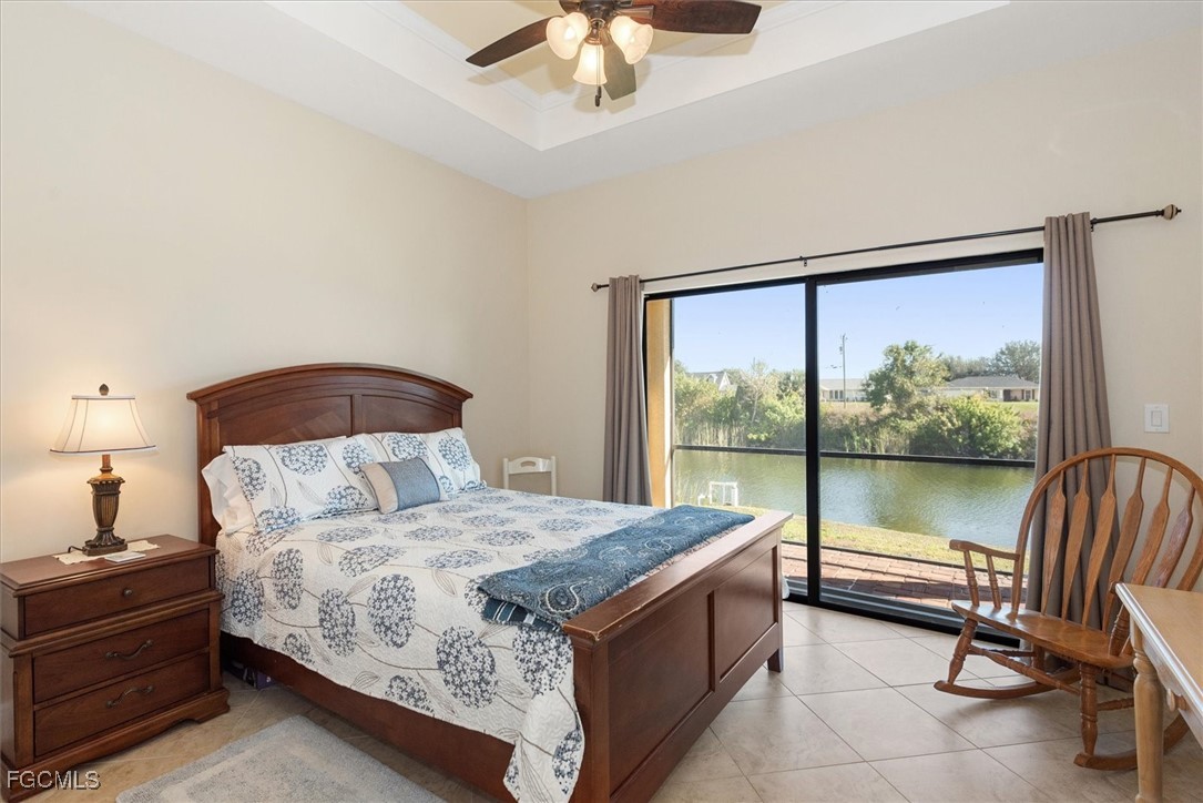 2011 Northwest 9th Place Cape Coral, FL 33993 - Photo 14 of 22 a bedroom with a bed and a chandelier