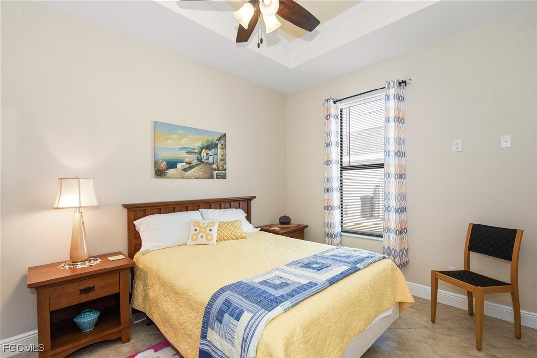 2011 Northwest 9th Place Cape Coral, FL 33993 - Photo 15 of 22 a bedroom with a bed and a lamp