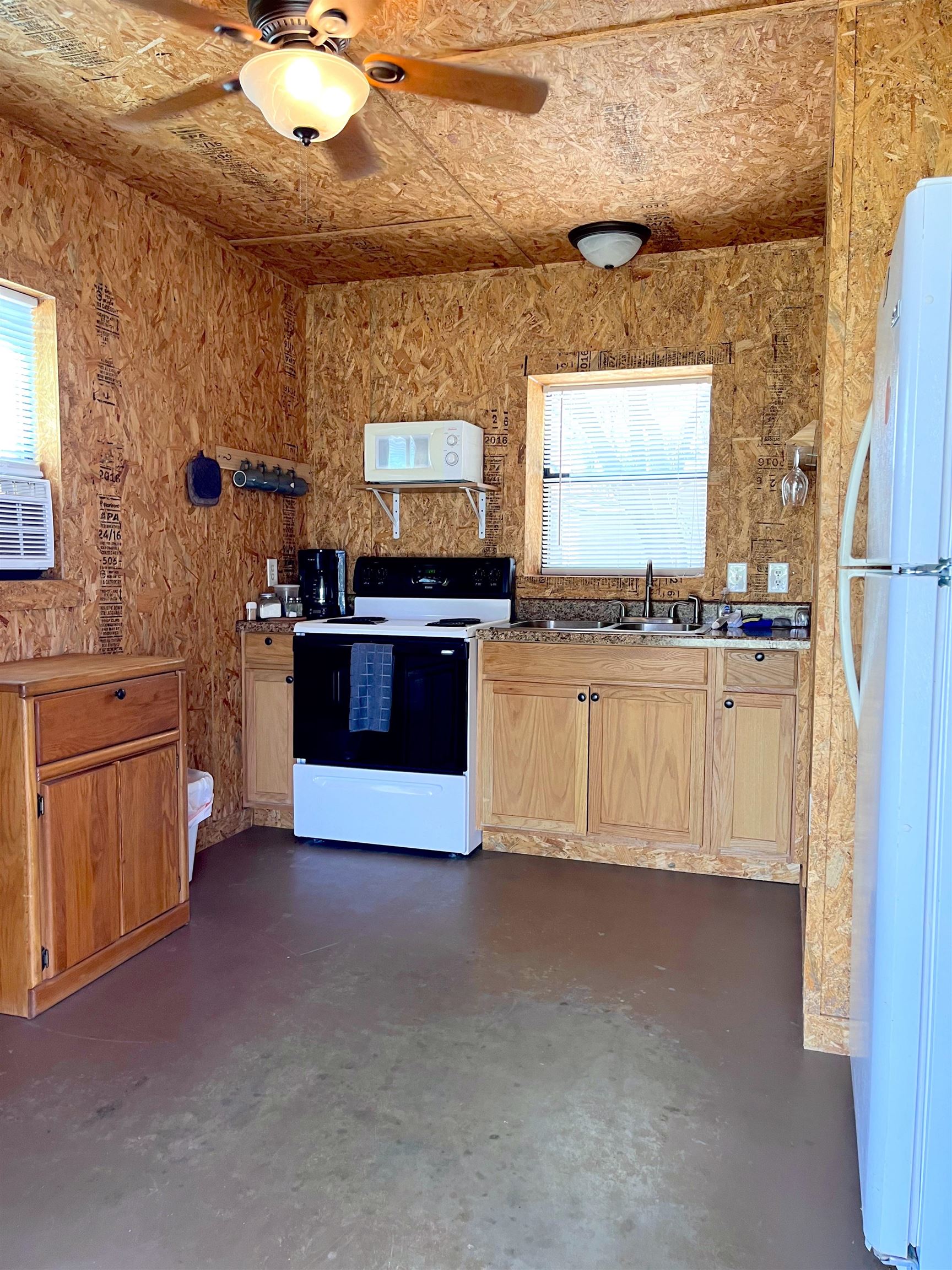 175 Elmer Road Llano, TX 78643 - Photo 18 of 25 a kitchen with stainless steel appliances a stove a sink and a refrigerator