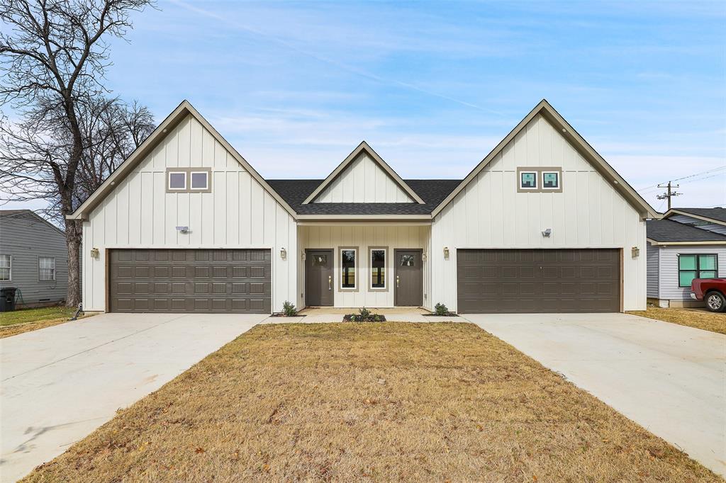a front view of a house with yard and garage