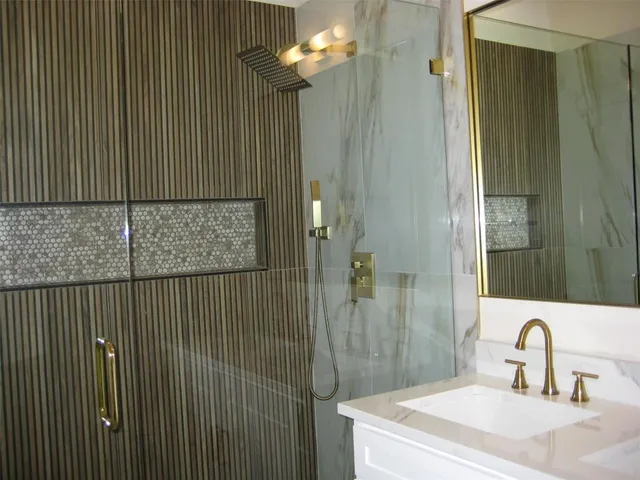 a bathroom with a sink a mirror and shower