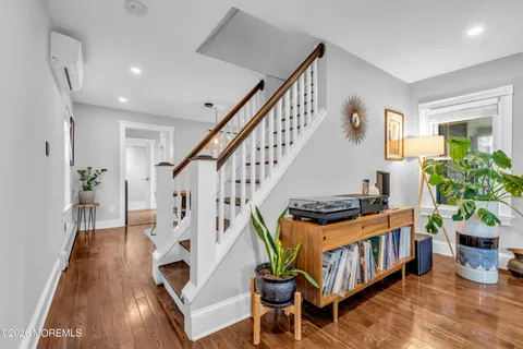 a view of entryway livingroom and hall with wooden floor