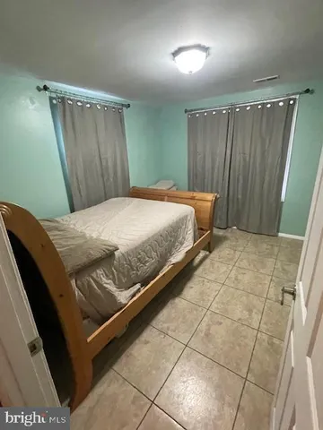 a bedroom with a bed and a mirror