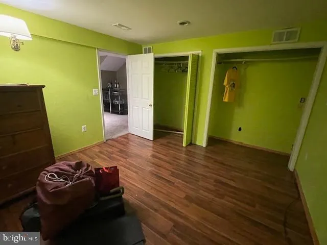 a bedroom with a bed and a green gate