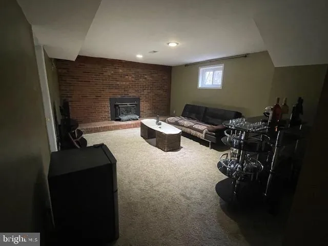 a dinning room with furniture a fireplace and a flat screen tv
