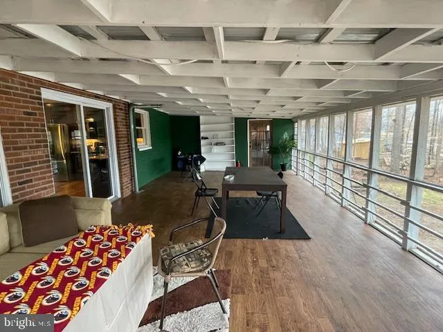 a living room with lots of furniture and large windows