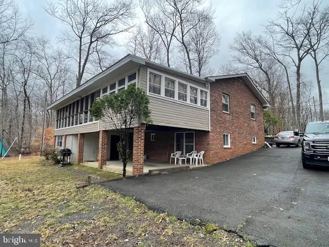 a view of a house with a yard covered in snow
