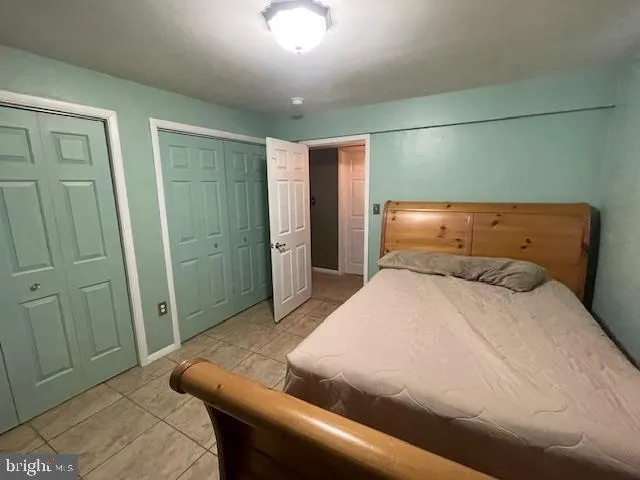 a bedroom with a bed and cabinets