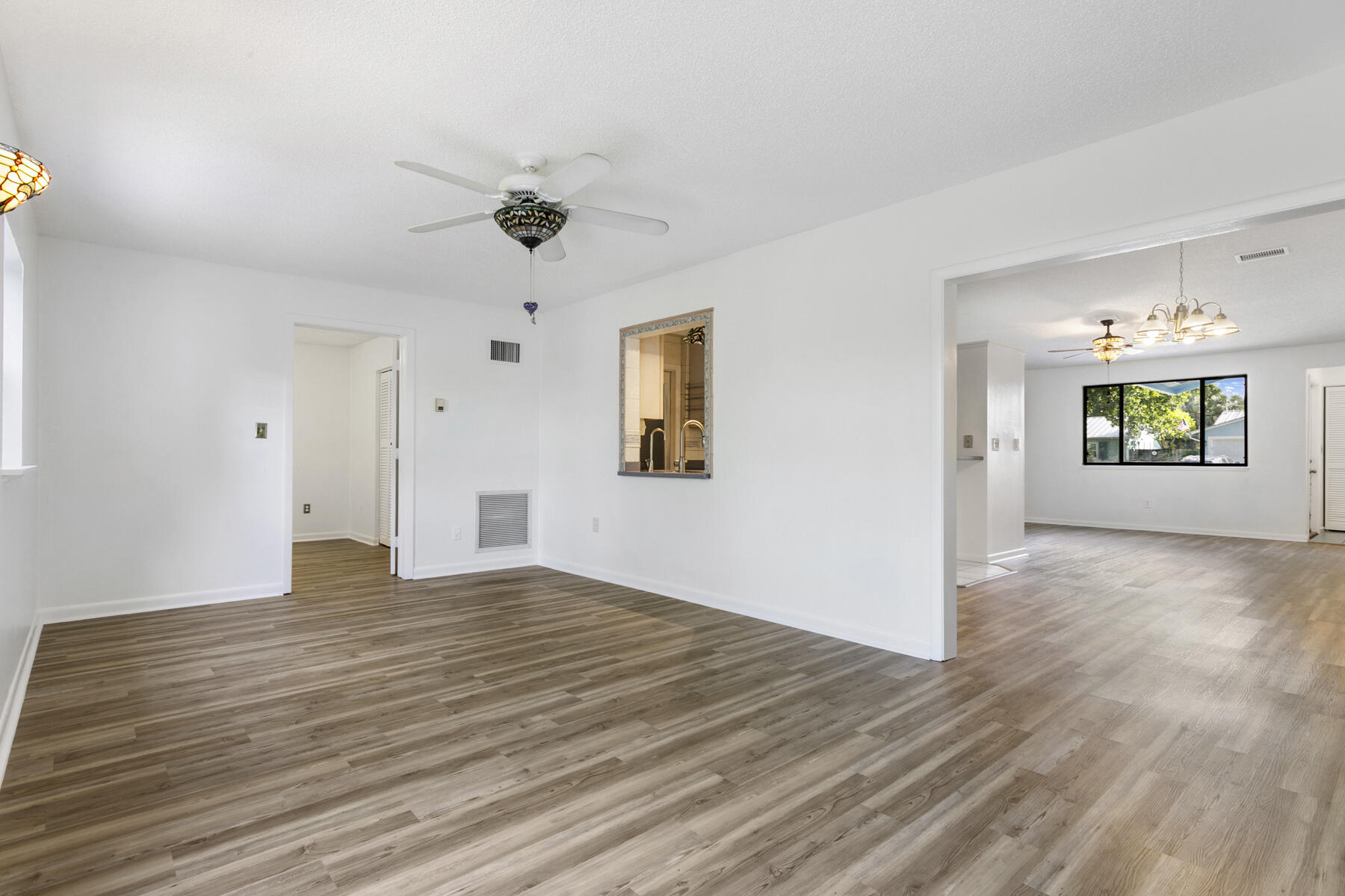 6075 Wolfe Street Jupiter, FL 33458 - Photo 14 of 27 a view of an empty room with window and wooden floor