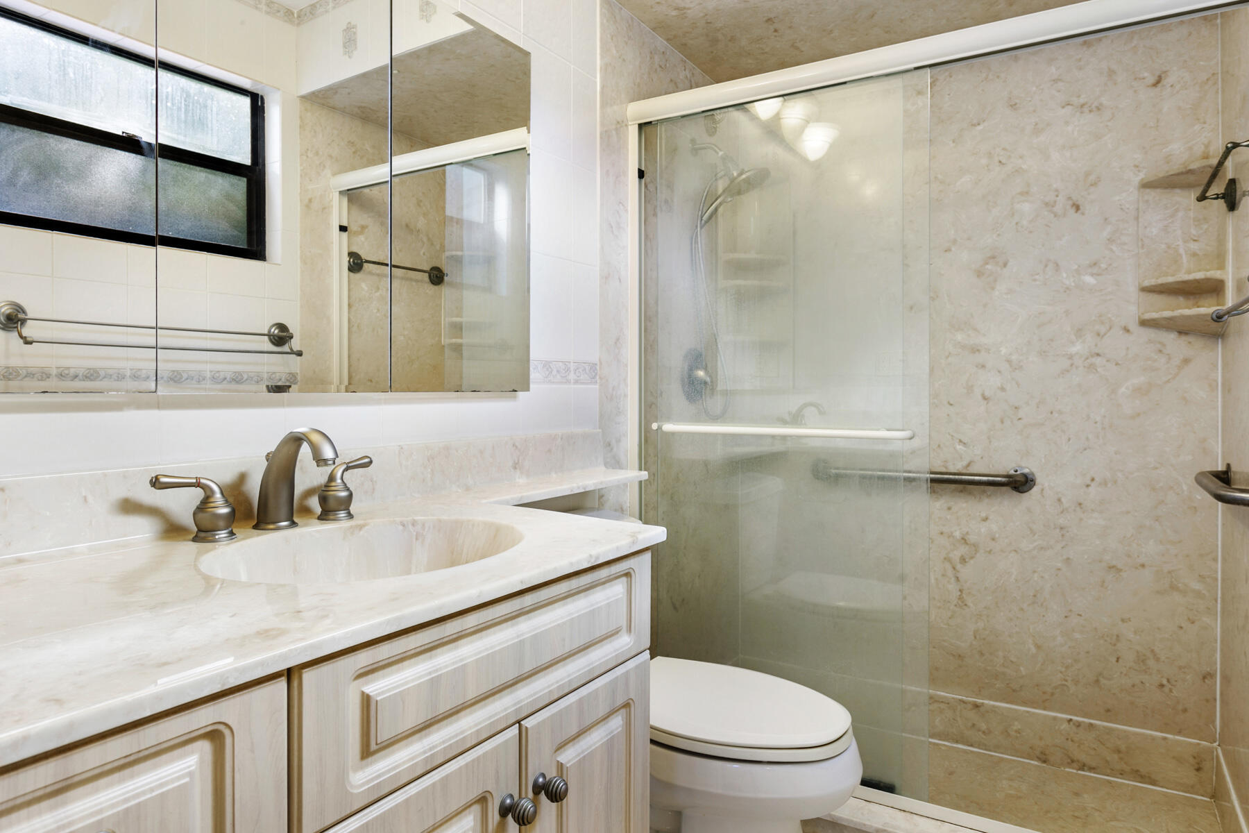 6075 Wolfe Street Jupiter, FL 33458 - Photo 18 of 27 a bathroom with a sink a toilet and shower