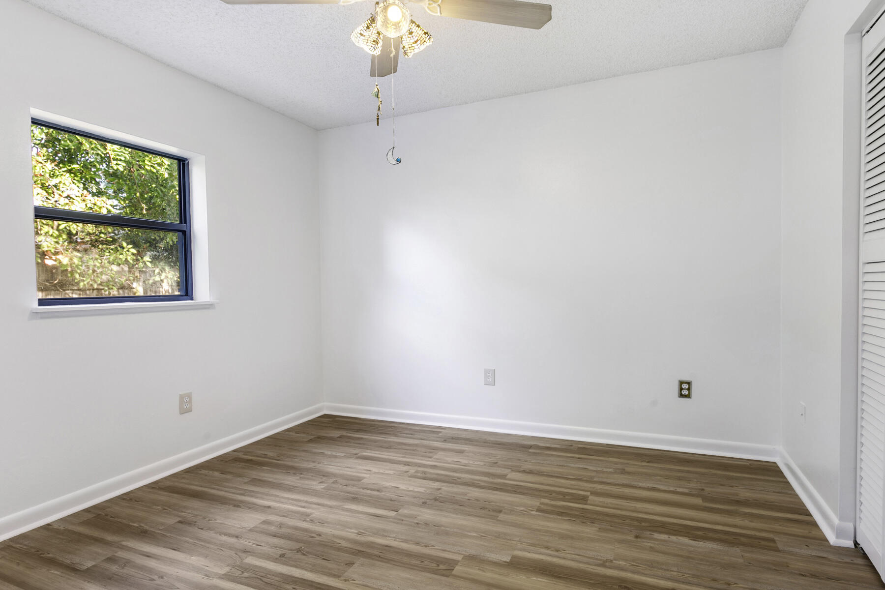 6075 Wolfe Street Jupiter, FL 33458 - Photo 21 of 27 a view of a room with wooden floor and window