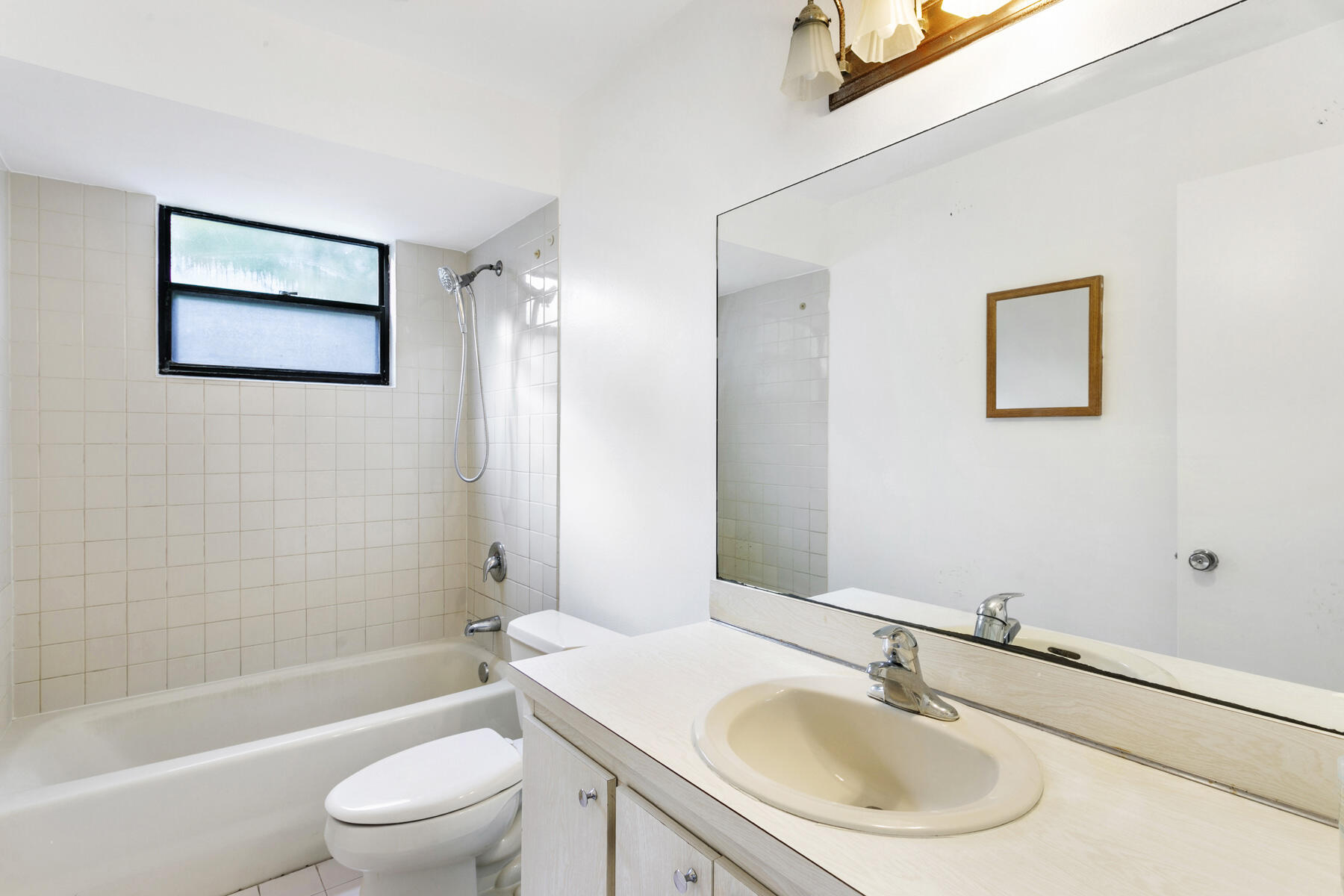 6075 Wolfe Street Jupiter, FL 33458 - Photo 22 of 27 a bathroom with a sink toilet and shower