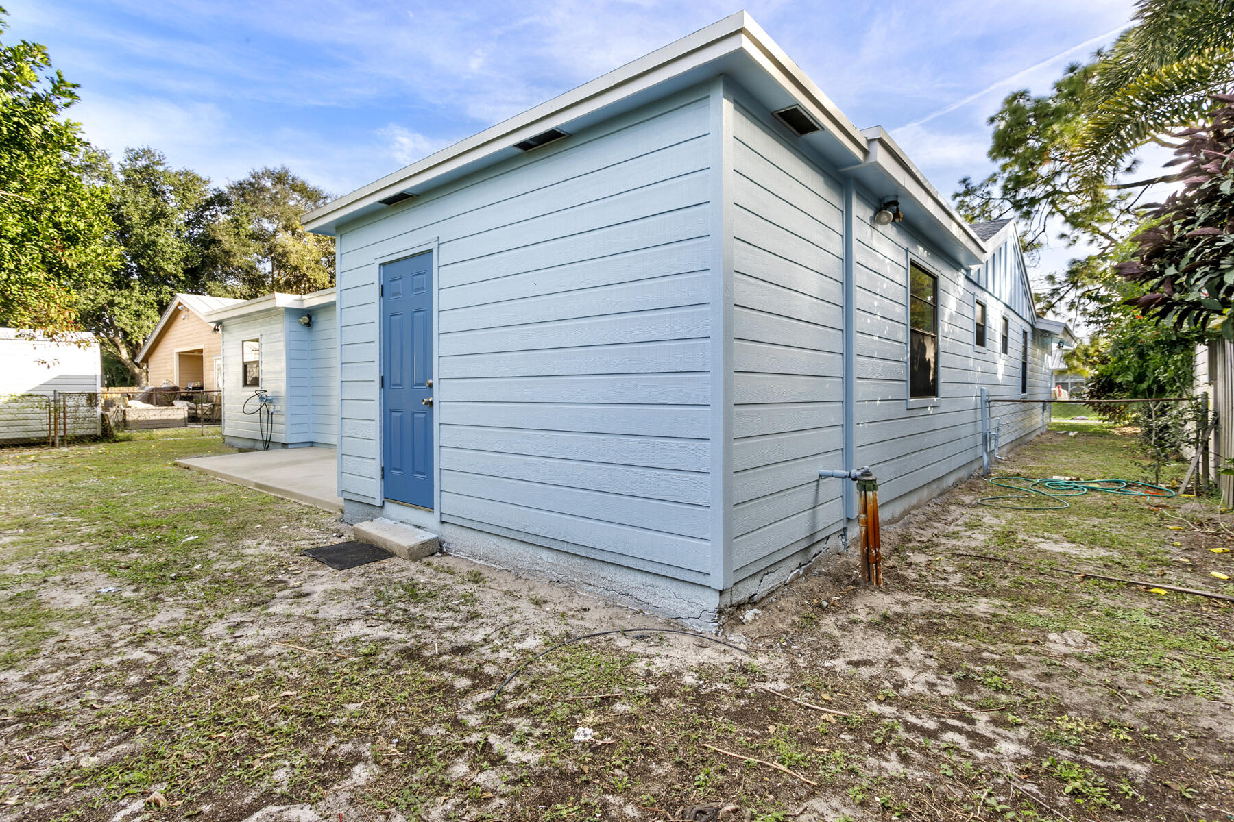 6075 Wolfe Street Jupiter, FL 33458 - Photo 26 of 27 a view of a house with a yard