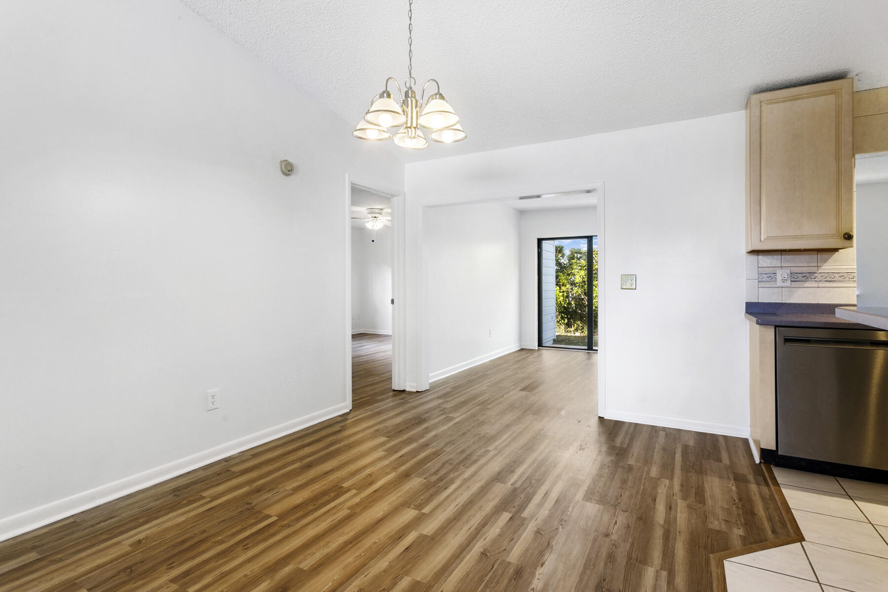 6075 Wolfe Street Jupiter, FL 33458 - Photo 5 of 27 a view of an empty room with window and wooden floor