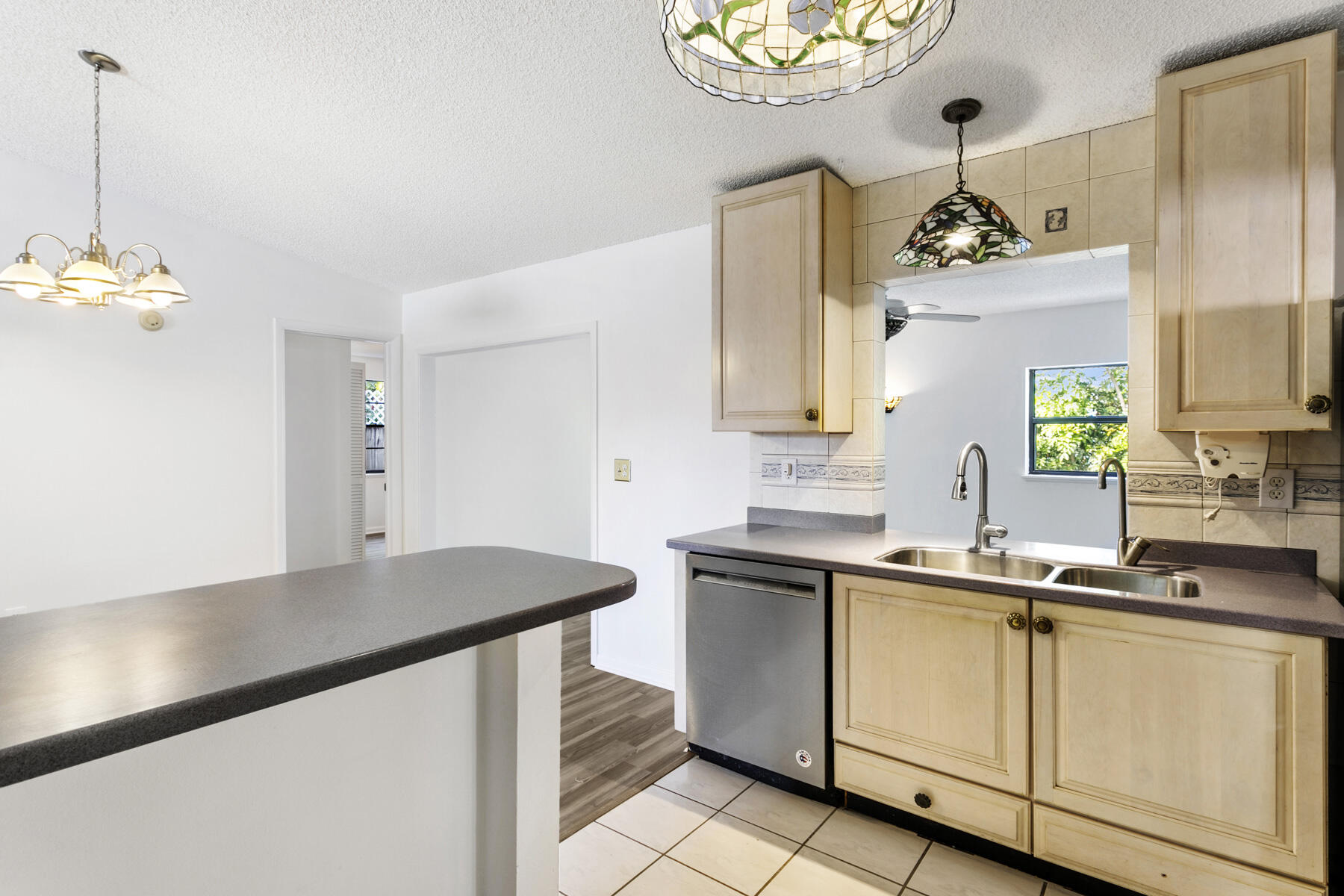 6075 Wolfe Street Jupiter, FL 33458 - Photo 10 of 27 a kitchen with a sink and cabinets