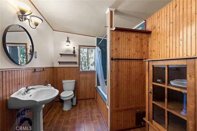 a kitchen with stainless steel appliances granite countertop a sink a stove and a wooden floors