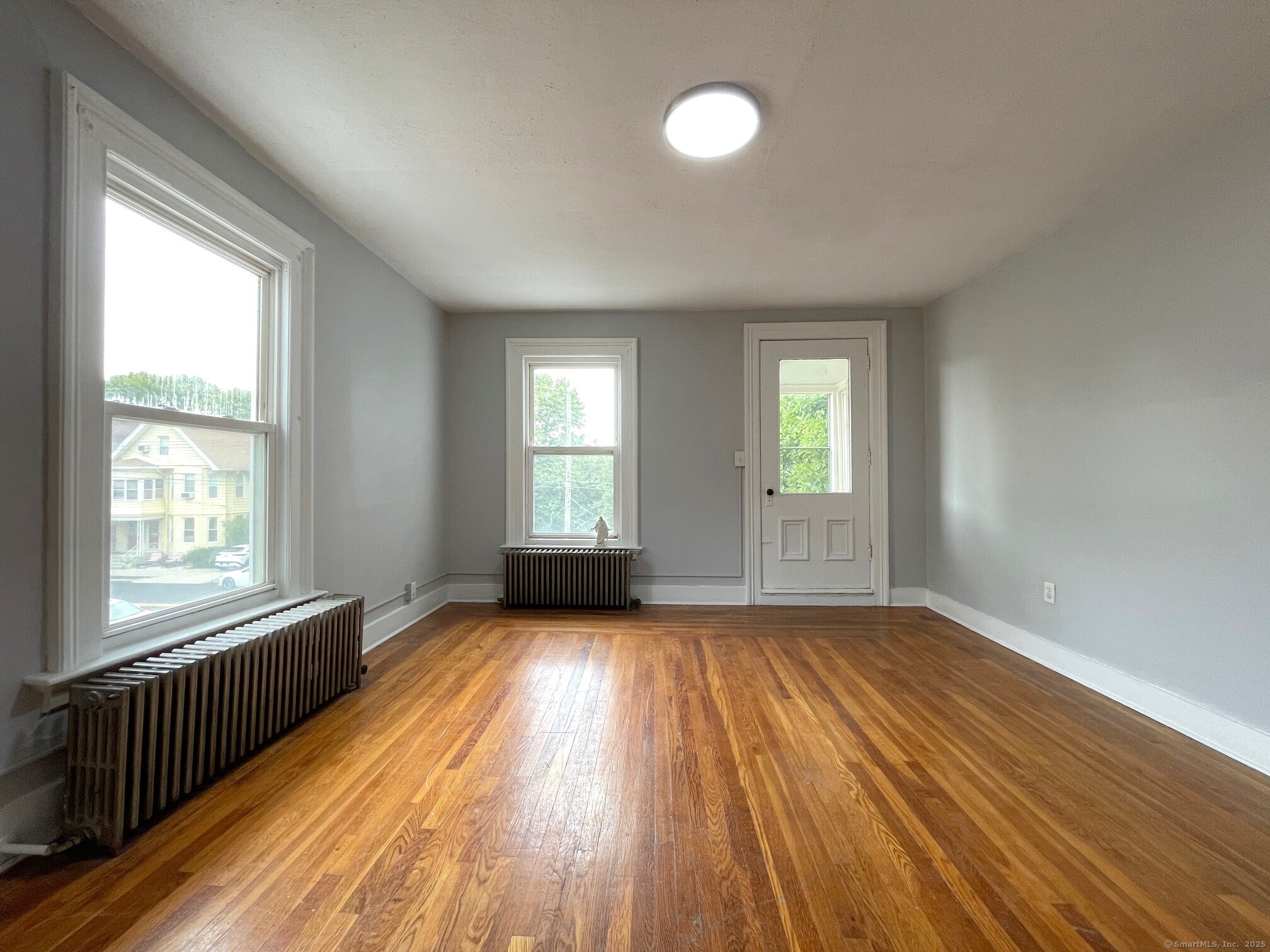 303 Lexington Avenue, Unit 2 New Haven, CT 06513 - Photo 2 of 11 a view of an empty room with wooden floor and a window