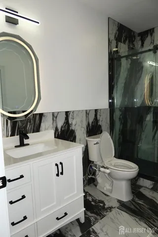 a bathroom with a sink a toilet and a mirror