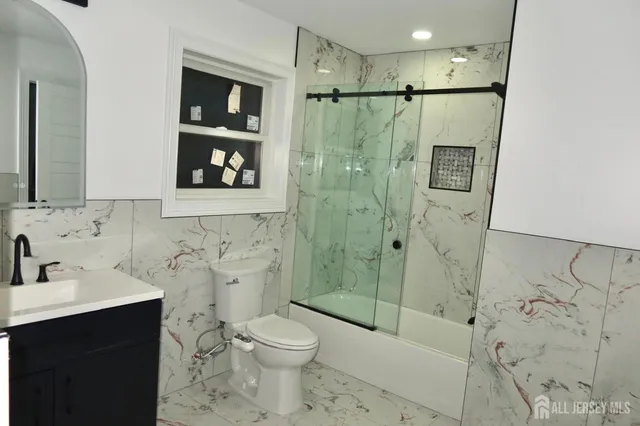 a bathroom with a shower toilet sink and mirror