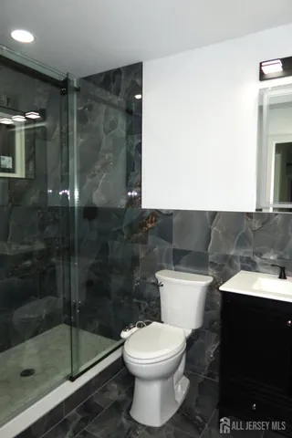 a bathroom with a toilet and a shower
