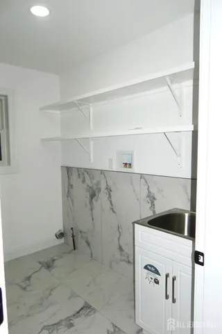 a bathroom with a shower sink and mirror