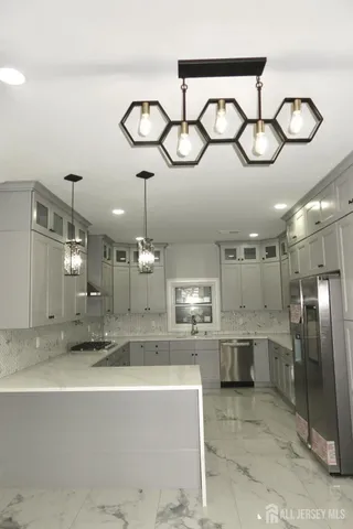 a view of a kitchen with a sink stainless steel appliances and cabinets