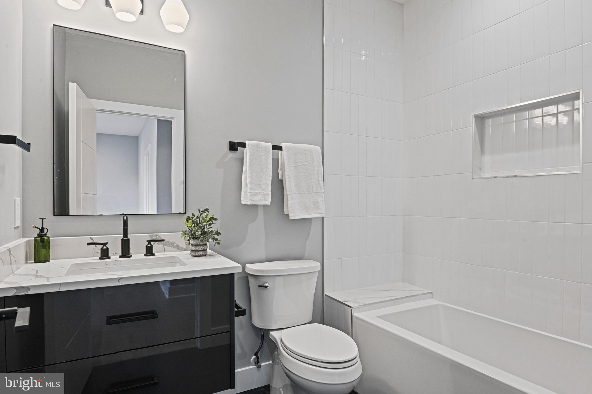 1052 Balls Hill Road McLean, VA 22101 - Photo 43 of 64 a bathroom with a sink a toilet and shower