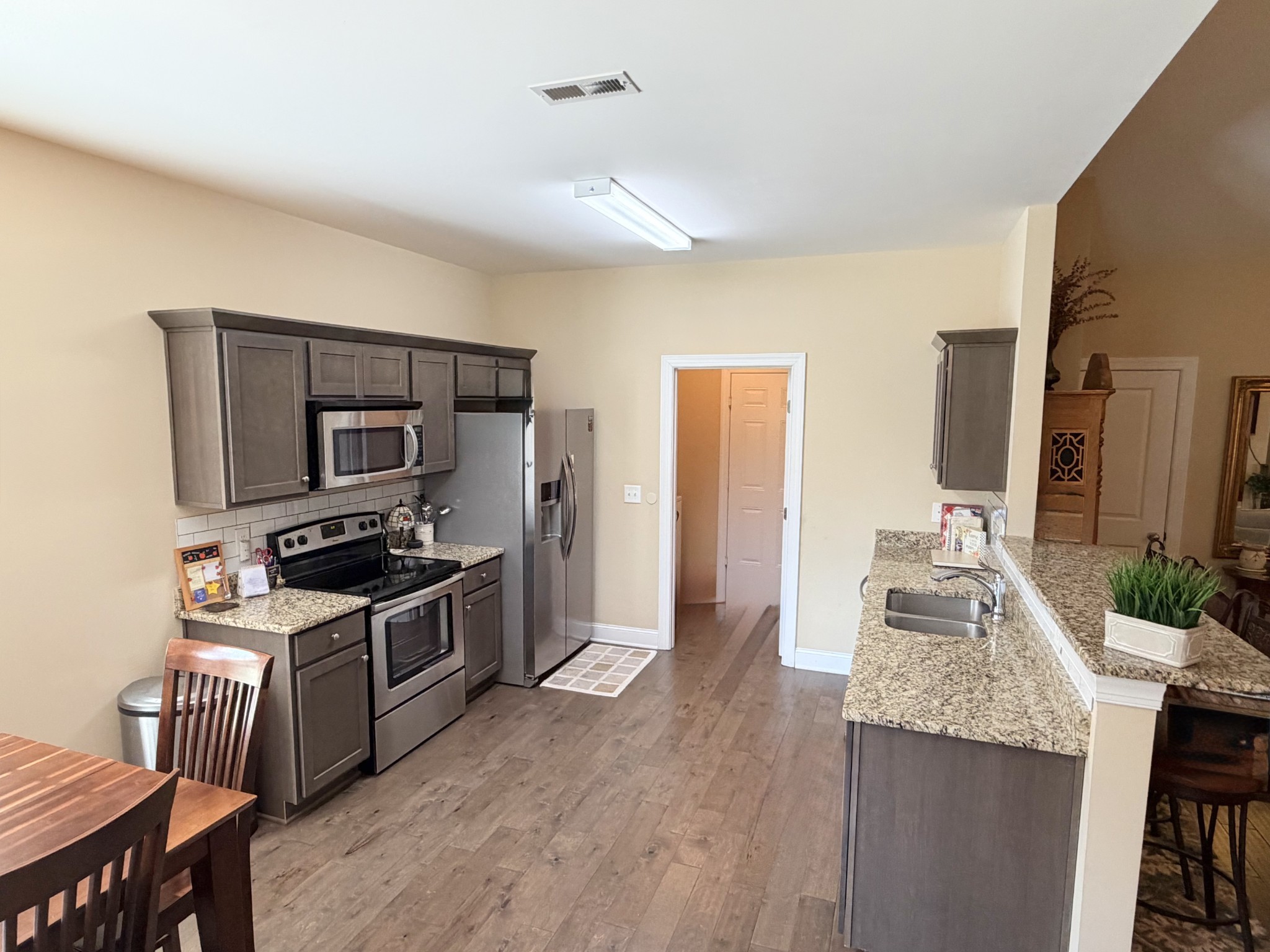 1001 Meadow View Drive Spring Hill, TN 37174 - Photo 13 of 34 a kitchen with granite countertop a stove and a wooden floors