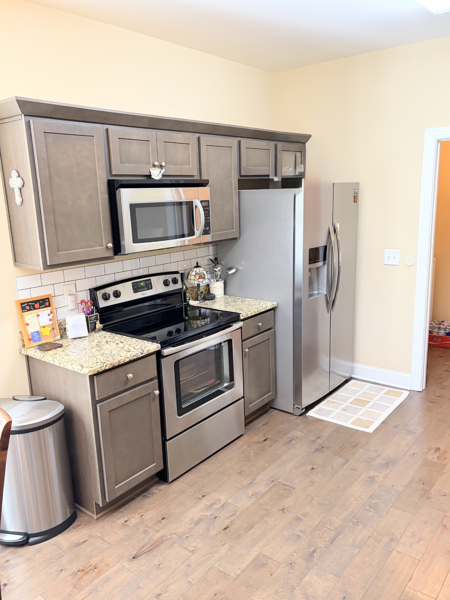 1001 Meadow View Drive Spring Hill, TN 37174 - Photo 14 of 34 a kitchen with stainless steel appliances a stove a microwave and a refrigerator