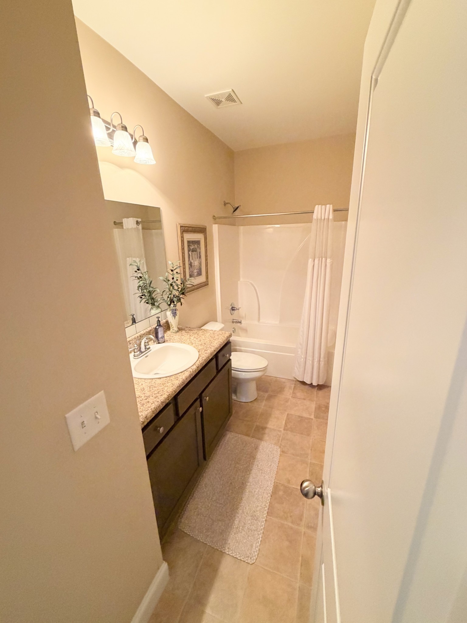 1001 Meadow View Drive Spring Hill, TN 37174 - Photo 27 of 34 a bathroom with a sink a mirror and a bathtub