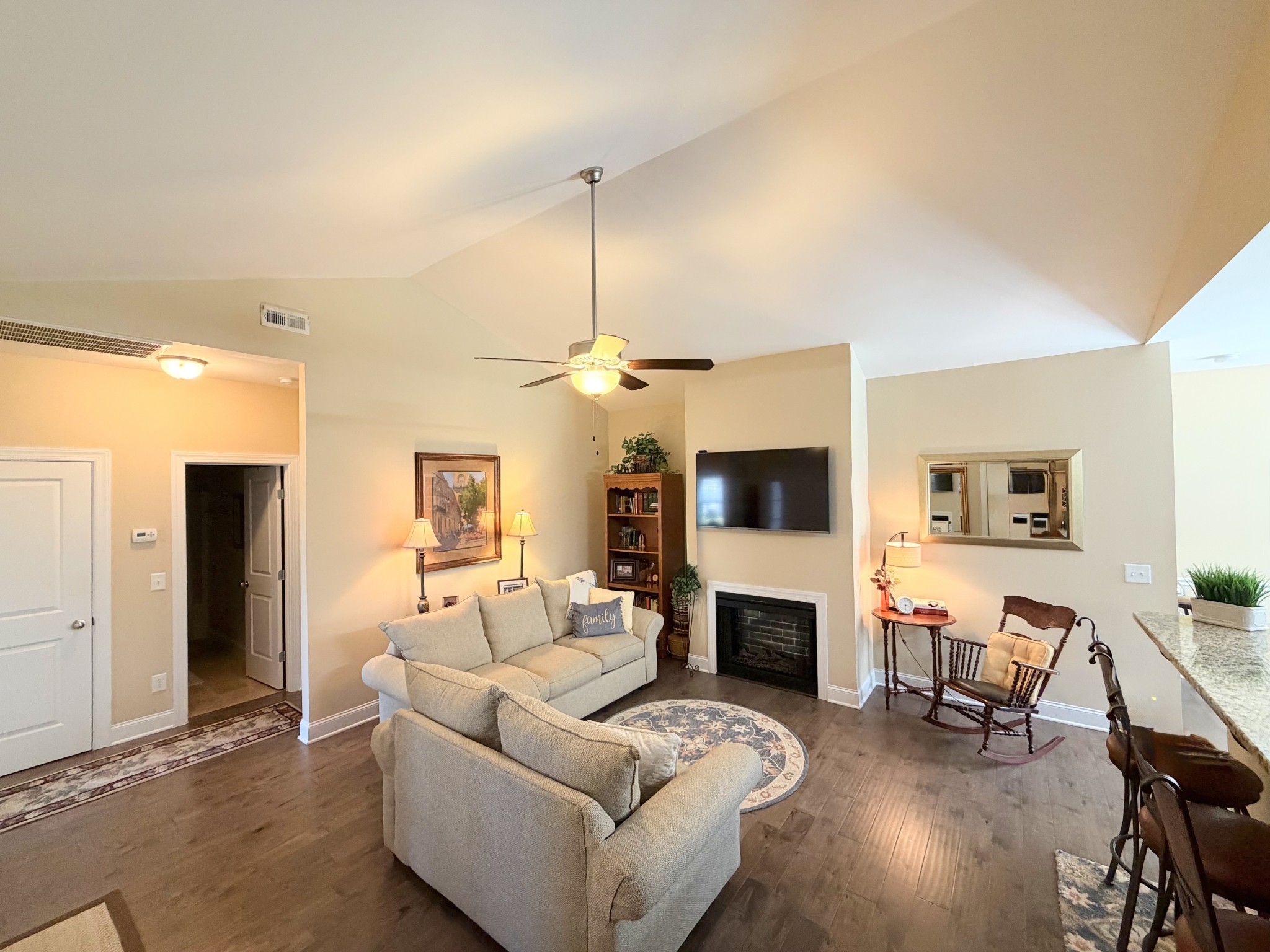 1001 Meadow View Drive Spring Hill, TN 37174 - Photo 10 of 34 a living room with furniture a fireplace and a flat screen tv