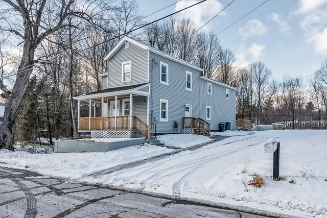 a view of a house with snow in the background