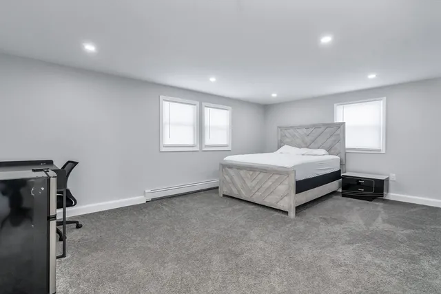 a spacious bedroom with a bed and a window