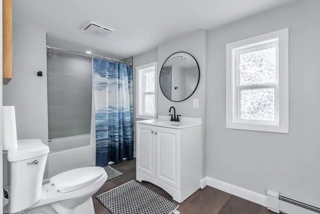 a bathroom with a toilet a sink and a mirror