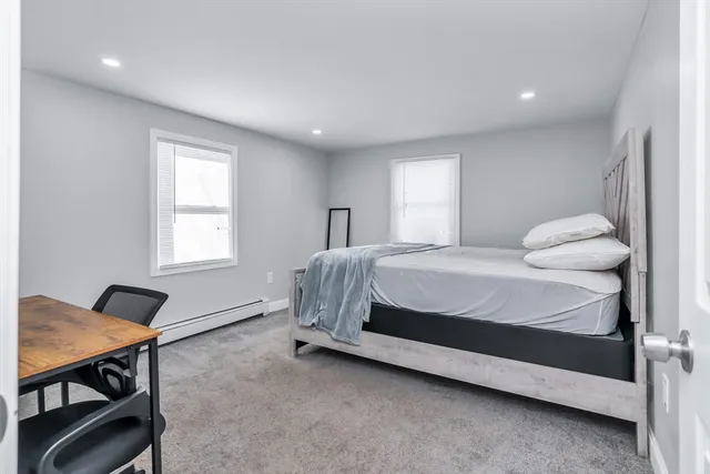 a bedroom with a bed and a desk