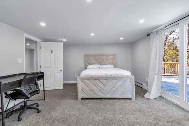 a bed room with a bed and a chair