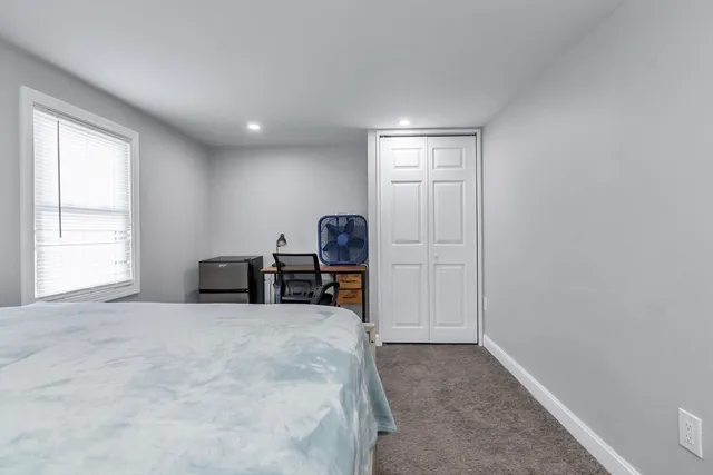 a view of a livingroom with a piano and wooden floor