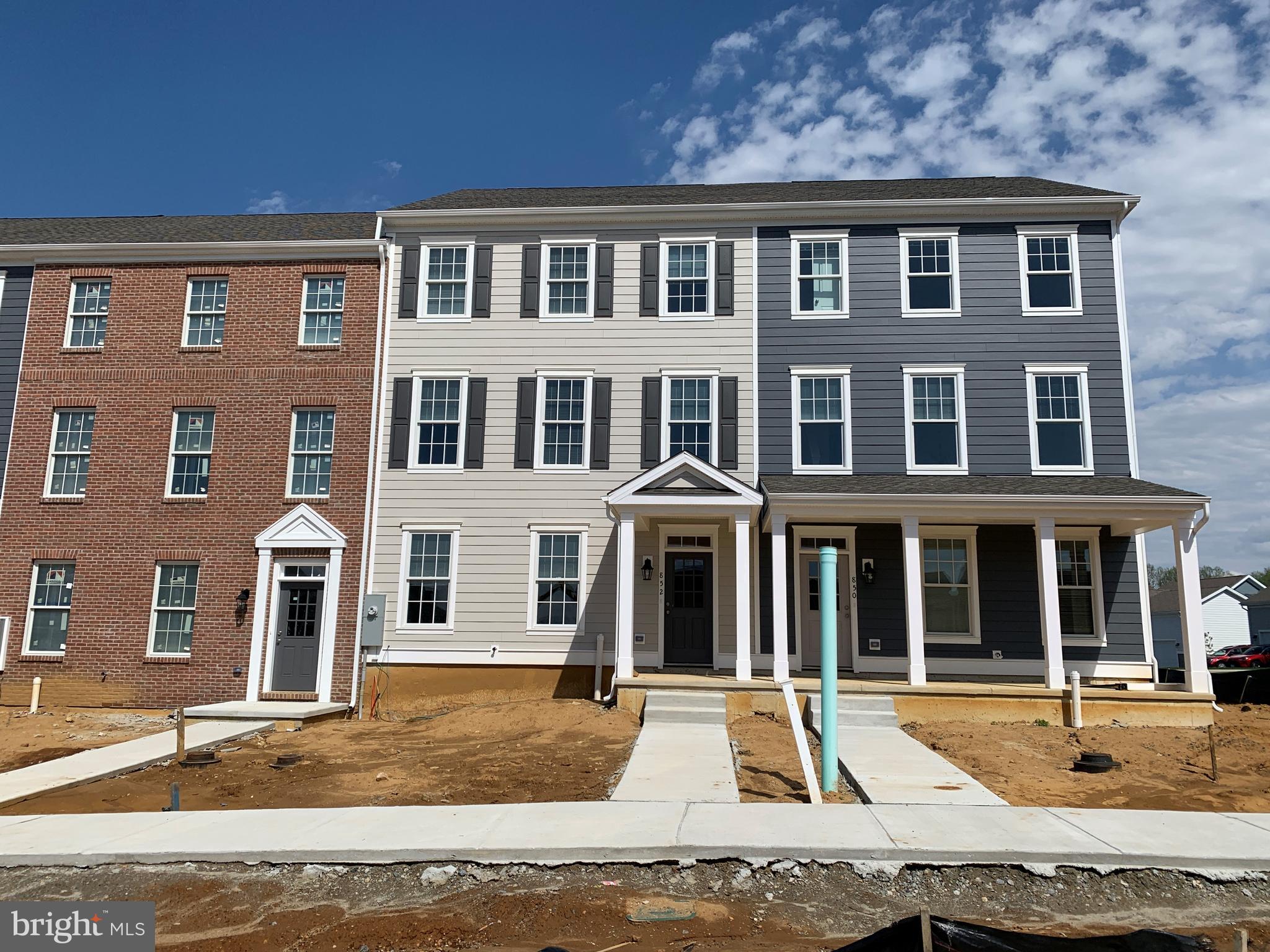 a front view of residential houses with yard