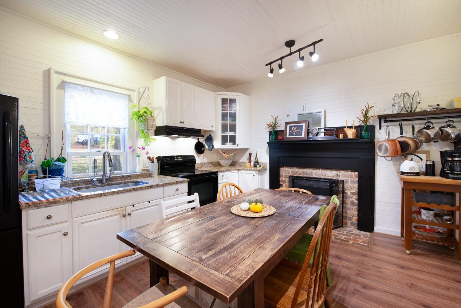 2417 Hodges Road Burlington, NC 27217 - Photo 7 of 30 a kitchen with a table chairs and a fireplace