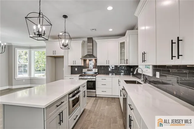 a open kitchen with stainless steel appliances granite countertop a sink stove and refrigerator