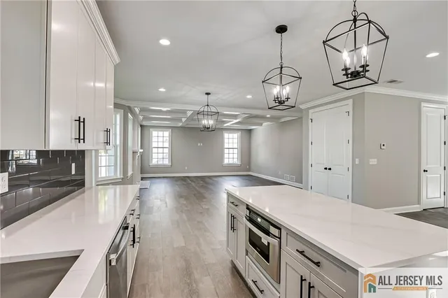 a kitchen with stainless steel appliances granite countertop a stove and a wooden floors
