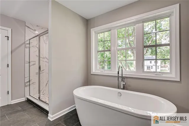 a spacious bathroom with a granite countertop sink and a mirror