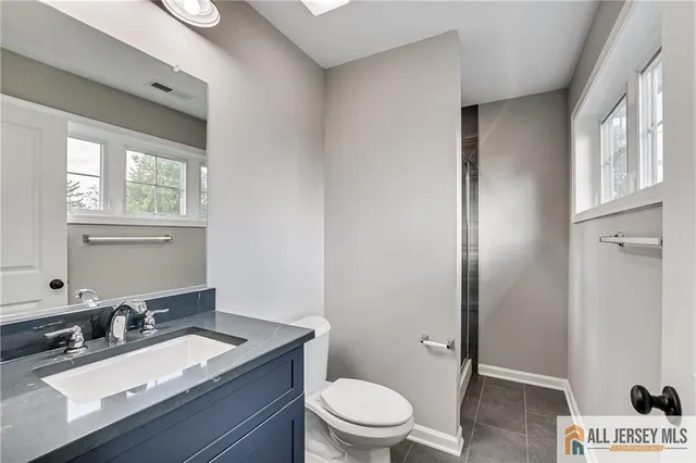 a bathroom with a double vanity sink and mirror